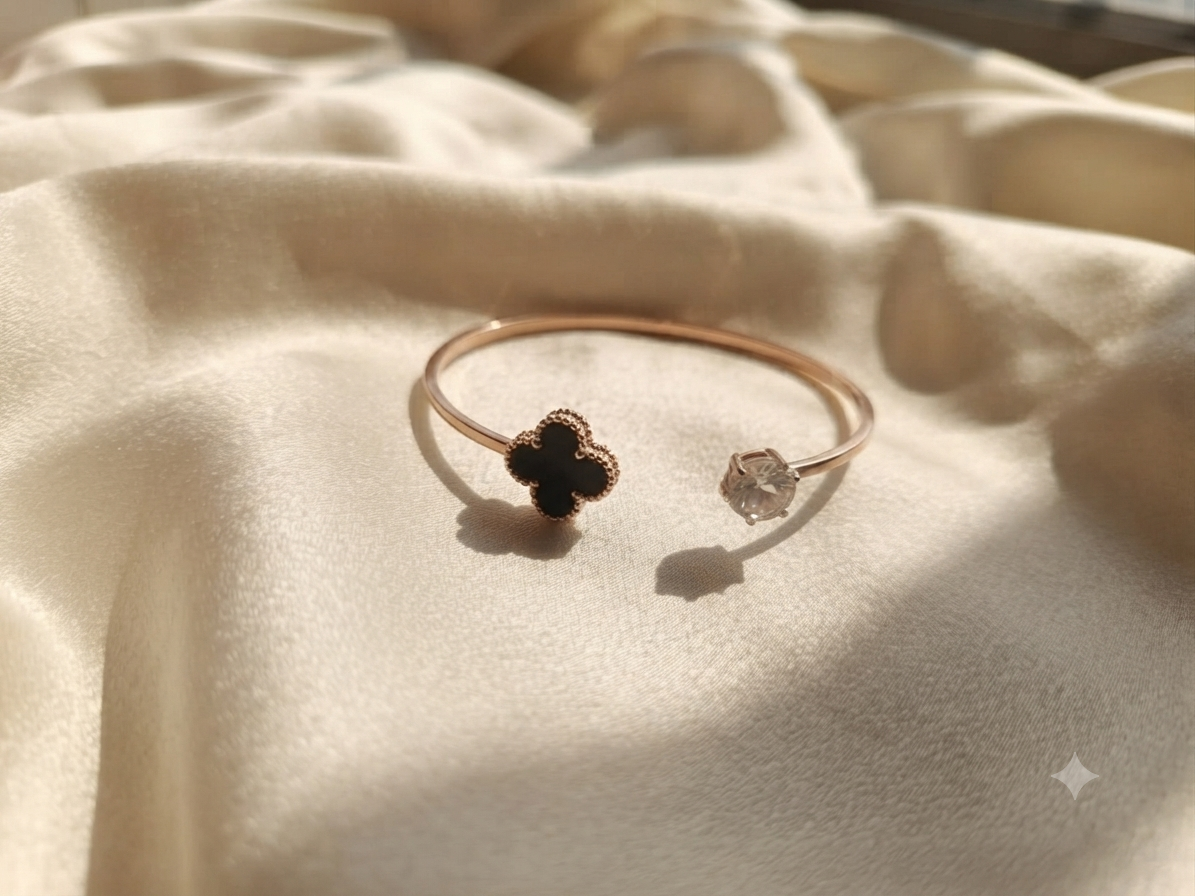 A graceful silver open cuff adorned with a brilliant crystal